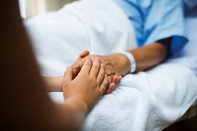 image of loved one holding a patients hand